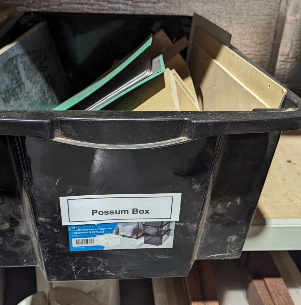 a tub with all of the pieces ready to make a possum box