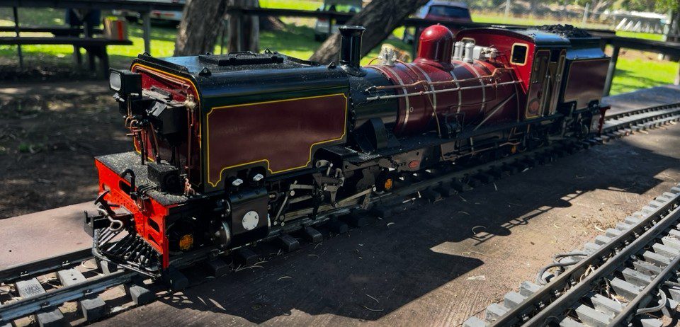 A photo of a large black live steam model trains